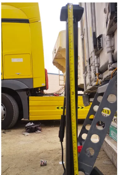 Measuring the internal depth of a truck diesel tank with a tape measure before cutting the fuel probe to length, UAE fleet workshop