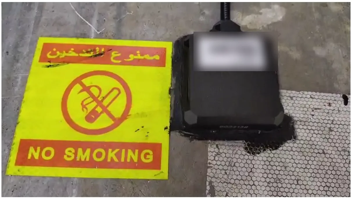 Omnicomm LLS 5 fuel sensor head mounted and sealed on the top of a truck diesel tank beside a No Smoking sign
