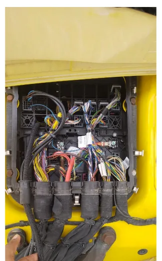 Truck cab junction box with wiring loom exposed during telematics fuel sensor installation